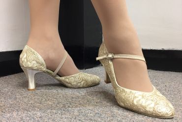 A pair of gold ballroom shoes